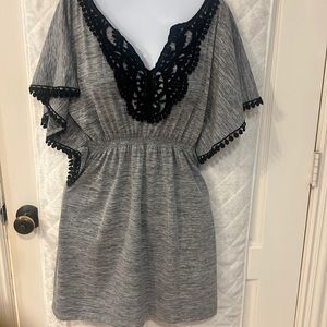 Beautiful and fun grey dress with crochet black trim.